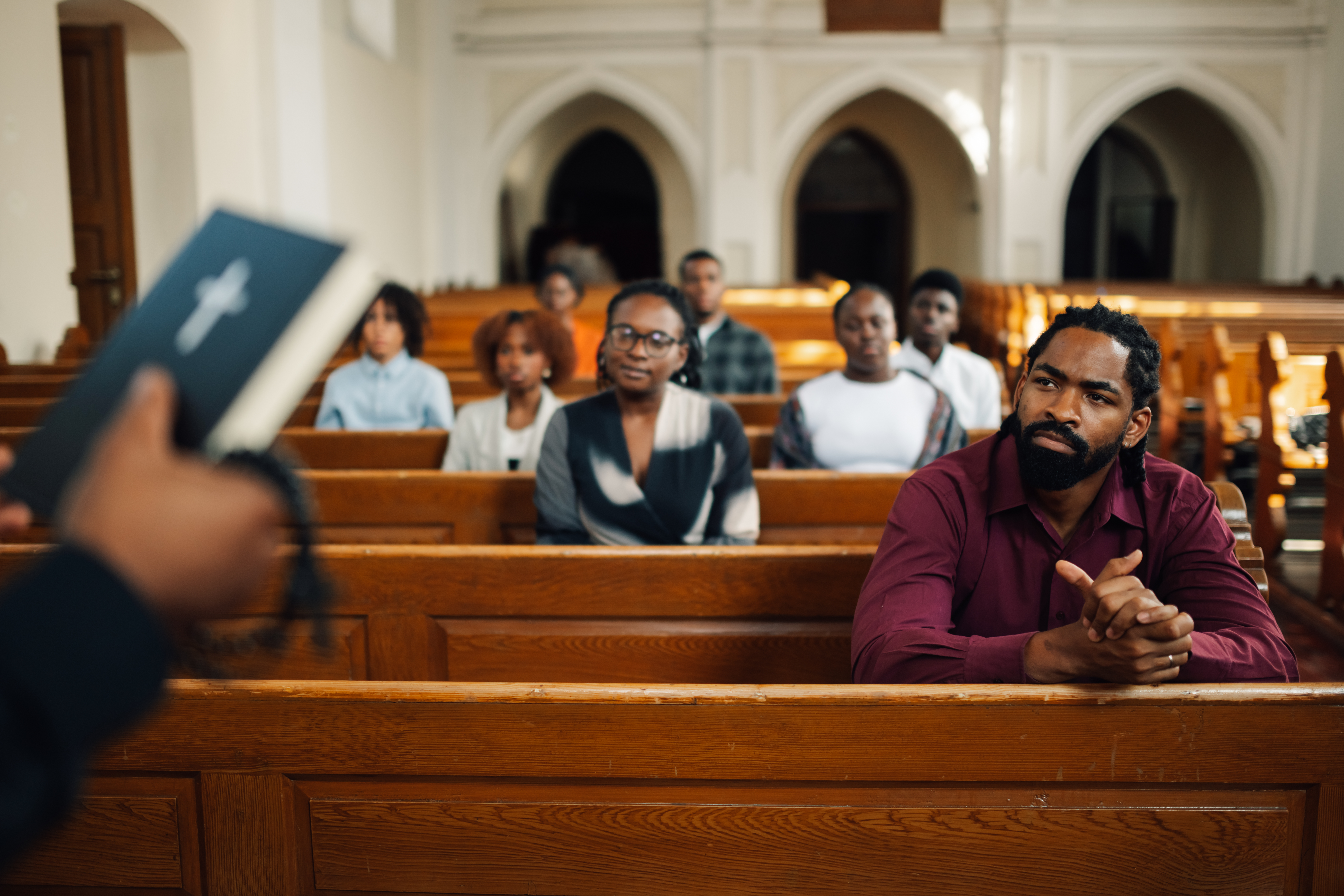 African American congregation listening to sermon during worship service.